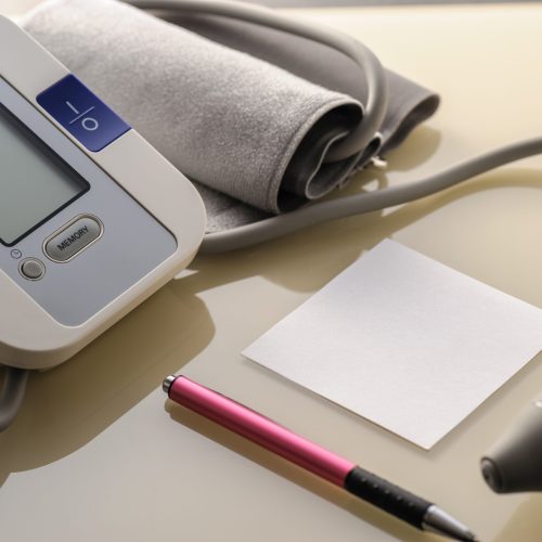 blood pressure monitor with sheet for notes on a light table