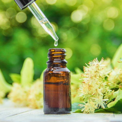 linden extract and flowers in a small bottle. Selective focus. linden extract and flowers in a small bottle. Selective focus.
