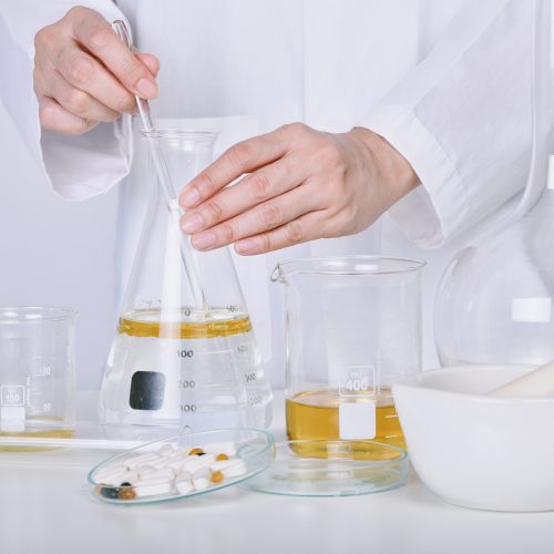 Oil pouring, Alternative herbal medicine, Mortar with healing botanical herbs, Natural organic botany and scientific glassware, Natural skin care beauty products. Oil pouring, Alternative herbal medicine, Mortar with healing botanical herbs, Natural organic botany and scientific glassware, Natural skin care beauty products.