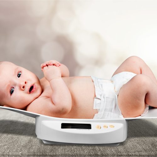 Beautiful baby boy on on weighing scale